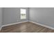 Well-lit bedroom featuring neutral walls and wood-look floors at 17314 Cape Horn Blvd, Punta Gorda, FL 33955