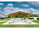Relaxing covered patio with tables and benches at 3300 Loveland Boulevard # 1904, Port Charlotte, FL 33980