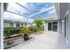 Spacious screened patio with tile floor, potted plants, and sliding glass doors at 3300 Loveland Boulevard # 1904, Port Charlotte, FL 33980