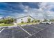 Exterior of villa showing parking spaces and landscaping at 3300 Loveland Boulevard # 1904, Port Charlotte, FL 33980