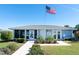 Community center building with landscaping and American flag at 3300 Loveland Boulevard # 1904, Port Charlotte, FL 33980