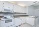 White kitchen with appliances and ample counter space at 3300 Loveland Boulevard # 1904, Port Charlotte, FL 33980