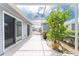 Screened-in patio with tile floor and lush plants at 3300 Loveland Boulevard # 1904, Port Charlotte, FL 33980