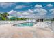 Community swimming pool with lounge chairs and umbrellas at 3300 Loveland Boulevard # 1904, Port Charlotte, FL 33980