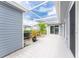 Screened patio with tile flooring, potted plants, and access to the interior at 3300 Loveland Boulevard # 1904, Port Charlotte, FL 33980