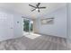 Bright bedroom with ceiling fan and sliding glass doors to a patio at 3300 Loveland Boulevard # 1904, Port Charlotte, FL 33980