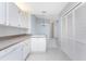 Bright kitchen features white cabinets, granite countertops, and a dishwasher at 3300 Loveland Boulevard # 1904, Port Charlotte, FL 33980