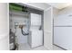 Laundry closet with washer, dryer and extra shelving at 3300 Loveland Boulevard # 1904, Port Charlotte, FL 33980