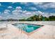Refreshing community pool area with surrounding lounge chairs at 3300 Loveland Boulevard # 1904, Port Charlotte, FL 33980