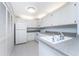 Kitchen with white cabinets and speckled countertops at 3300 Loveland Boulevard # 1904, Port Charlotte, FL 33980