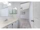 Bathroom features a vanity, mirror, and access to bedroom at 3300 Loveland Boulevard # 1904, Port Charlotte, FL 33980