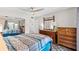 Main bedroom with king-size bed and dresser, access to a balcony and bathroom at 22375 Edgewater Dr # 126, Port Charlotte, FL 33980