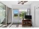 Bright sunroom features sliding glass doors, a TV, and access to the outdoors at 22375 Edgewater Dr # 126, Port Charlotte, FL 33980