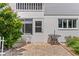Private patio with brick pavers, wrought iron furniture, and landscaping at 22375 Edgewater Dr # 126, Port Charlotte, FL 33980