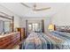 Main bedroom with a king-size bed, dresser, and access to a private balcony at 22375 Edgewater Dr # 126, Port Charlotte, FL 33980