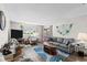 Spacious living area with hardwood floors, comfortable seating, and large TV at 22375 Edgewater Dr # 126, Port Charlotte, FL 33980