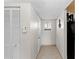 Condo hallway with tile flooring and access to exterior at 22375 Edgewater Dr # 126, Port Charlotte, FL 33980