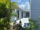 White patio area with tropical landscaping at 3300 Loveland Blvd # 2903, Punta Gorda, FL 33980