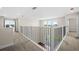 Open and airy second floor hallway with a view of the first floor at 42548 Little Ridge Rd, Punta Gorda, FL 33982