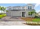 Two-story home exterior with three-car garage and landscaping at 42548 Little Ridge Rd, Punta Gorda, FL 33982