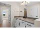 Modern bathroom with white vanity, gray countertop, and black fixtures at 42548 Little Ridge Rd, Punta Gorda, FL 33982