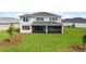 Home with a large backyard, screened patio, and lush green lawn at 42548 Little Ridge Rd, Punta Gorda, FL 33982