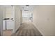 Upstairs hallway with carpet, leading to bedrooms and laundry at 42548 Little Ridge Rd, Punta Gorda, FL 33982