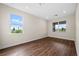 Simple bedroom with hardwood floors and large windows at 42548 Little Ridge Rd, Punta Gorda, FL 33982