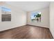 Bright bedroom with wood-look flooring and large windows at 42548 Little Ridge Rd, Punta Gorda, FL 33982