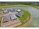 Aerial view of new homes surrounding a lake at 42548 Little Ridge Rd, Punta Gorda, FL 33982