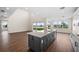 Open floor plan with kitchen island, hardwood floors, and large windows at 42548 Little Ridge Rd, Punta Gorda, FL 33982