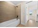 Clean and functional bathroom with a bathtub and neutral tile at 42548 Little Ridge Rd, Punta Gorda, FL 33982