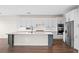 Modern kitchen with white cabinets, a large island, and stainless steel appliances at 42548 Little Ridge Rd, Punta Gorda, FL 33982