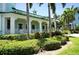 Charming teal building with white accents and tropical landscaping at 5123 Melbourne St # D104, Port Charlotte, FL 33980