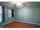 Bright bedroom with wood floors, ceiling fan, and window coverings at 5123 Melbourne St # D104, Port Charlotte, FL 33980