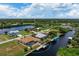 Aerial view of single Gathering home on waterfront lot with private pool at 5149 Latham Ter, Port Charlotte, FL 33981