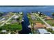 Aerial view highlighting a waterfront home with a private dock and pool at 5149 Latham Ter, Port Charlotte, FL 33981