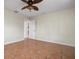 Bedroom with tile floors, ceiling fan and access to kitchen at 5149 Latham Ter, Port Charlotte, FL 33981