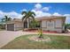 One-story home with a large garage and landscaped yard at 5149 Latham Ter, Port Charlotte, FL 33981