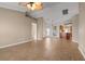 Bright living room with tile floors, high ceilings, and access to kitchen at 5149 Latham Ter, Port Charlotte, FL 33981
