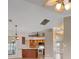 Open living room and kitchen with tile floors and ceiling fans at 5149 Latham Ter, Port Charlotte, FL 33981