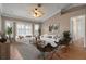 Living room with vaulted ceilings, large windows, and comfortable seating at 5149 Latham Ter, Port Charlotte, FL 33981