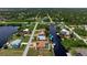 Aerial view of waterfront home with private pool and boat dock at 5149 Latham Ter, Port Charlotte, FL 33981