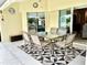 Covered patio furnished with a table and chairs for outdoor dining at 530 Kensington St, Port Charlotte, FL 33954
