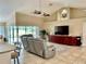 Bright living room with vaulted ceilings, recessed lighting, and sliding glass doors leading to the pool at 530 Kensington St, Port Charlotte, FL 33954