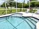 Inviting screened-in pool area with ample space for relaxation at 530 Kensington St, Port Charlotte, FL 33954