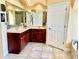 Bathroom with double vanity and a large mirror at 530 Kensington St, Port Charlotte, FL 33954