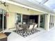 Outdoor patio with table and chairs, adjacent to the house at 530 Kensington St, Port Charlotte, FL 33954