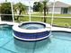 Relaxing pool and spa with blue tile accents at 530 Kensington St, Port Charlotte, FL 33954
