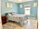 Bedroom with double bed, light blue walls, and tiled floor at 530 Kensington St, Port Charlotte, FL 33954